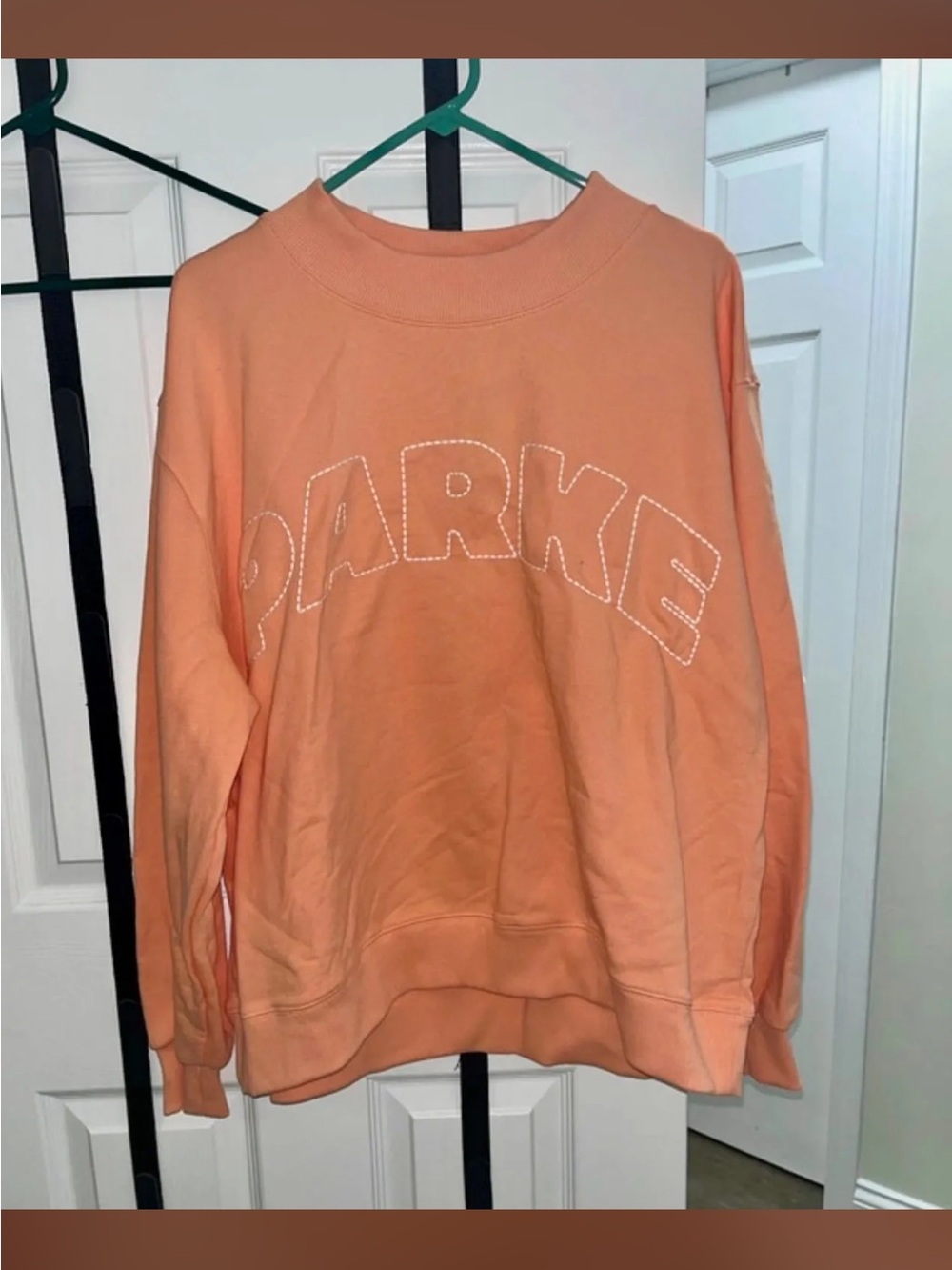 Women’s “Parke” brand pullover crewneck. Dreamsicle Orange with white stitching